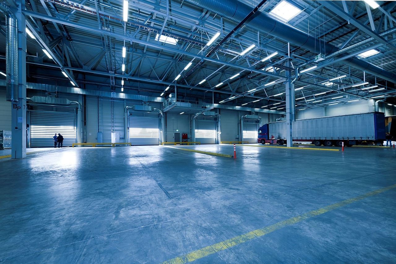 interior of big empty warehouse with concrete flooring